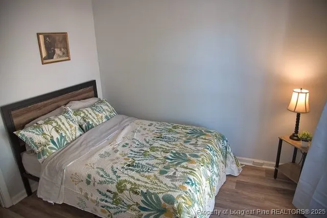 a bed sitting in a bedroom next to a lamp