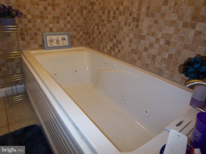 8809 Sigrid Road Randallstown, MD 21133 - Photo 8 of 15 a view of a bathtub in a bathroom
