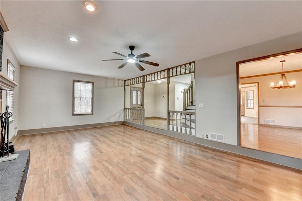 2377 Centerville Rosebud Road Loganville, GA 30052 - Photo 11 of 76 a view of an empty room with a window and wooden floor
