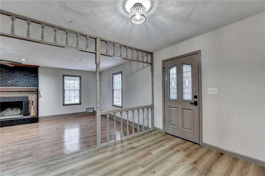 2377 Centerville Rosebud Road Loganville, GA 30052 - Photo 12 of 76 a view of an empty room with wooden floor fireplace and a window