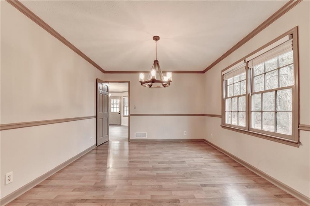 2377 Centerville Rosebud Road Loganville, GA 30052 - Photo 17 of 76 wooden floor in an empty room with a window