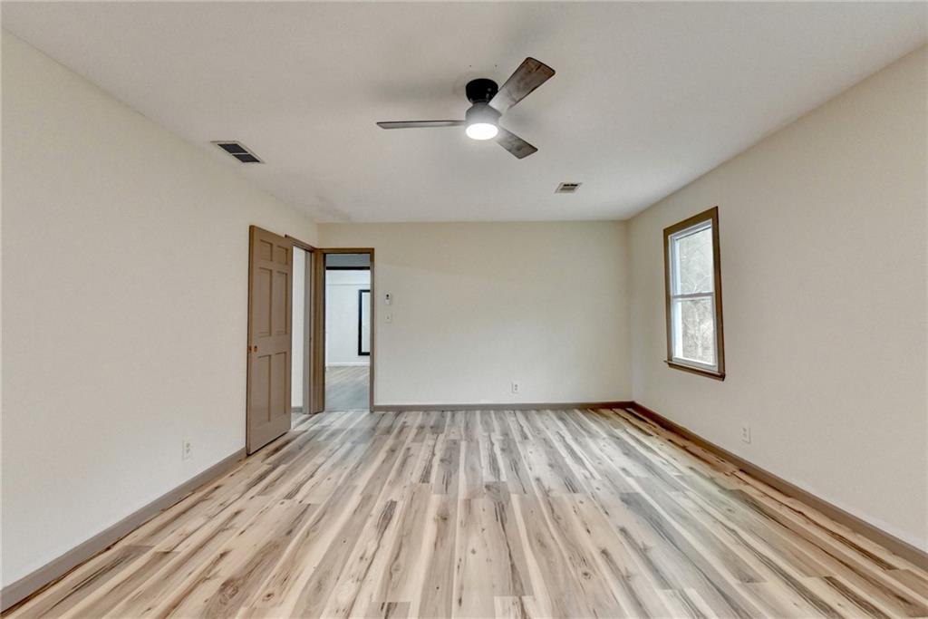2377 Centerville Rosebud Road Loganville, GA 30052 - Photo 29 of 76 wooden floor in an empty room with a window