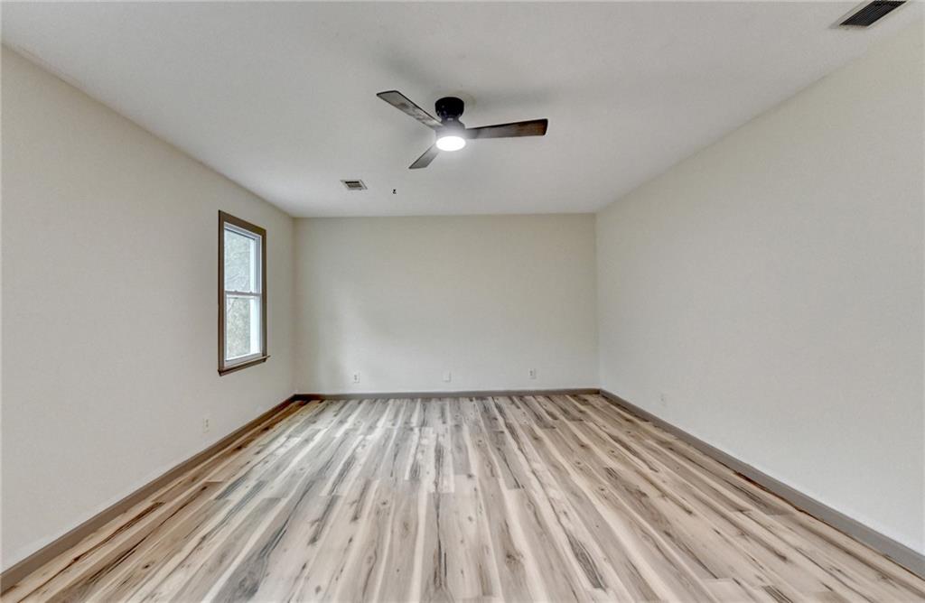 2377 Centerville Rosebud Road Loganville, GA 30052 - Photo 32 of 76 wooden floor in an empty room with a window