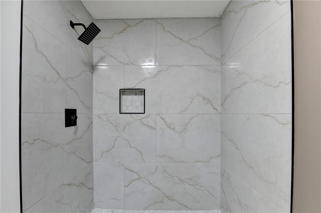 2377 Centerville Rosebud Road Loganville, GA 30052 - Photo 37 of 76 a bathroom with a shower