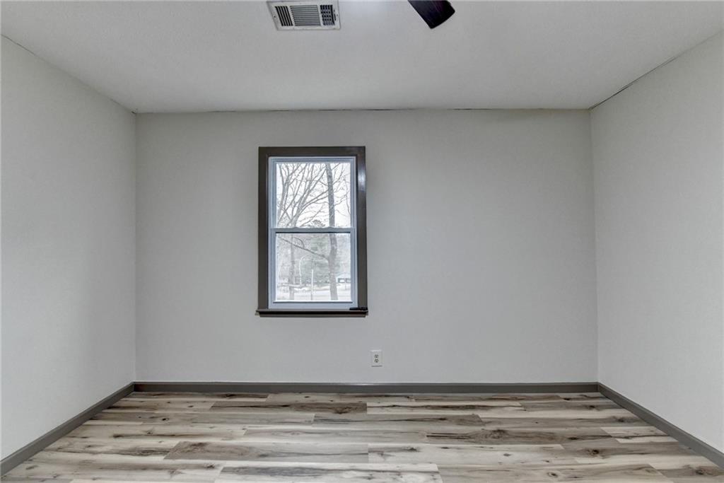 2377 Centerville Rosebud Road Loganville, GA 30052 - Photo 38 of 76 a view of an empty room with wooden floor and a window