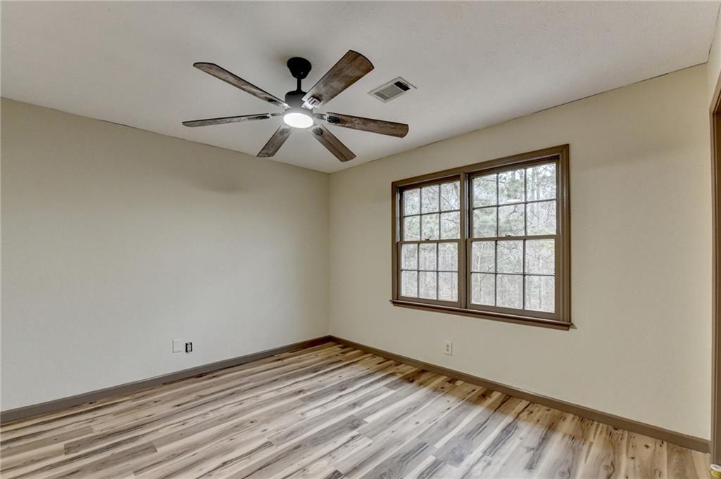 2377 Centerville Rosebud Road Loganville, GA 30052 - Photo 45 of 76 a view of empty room with wooden floor and fan