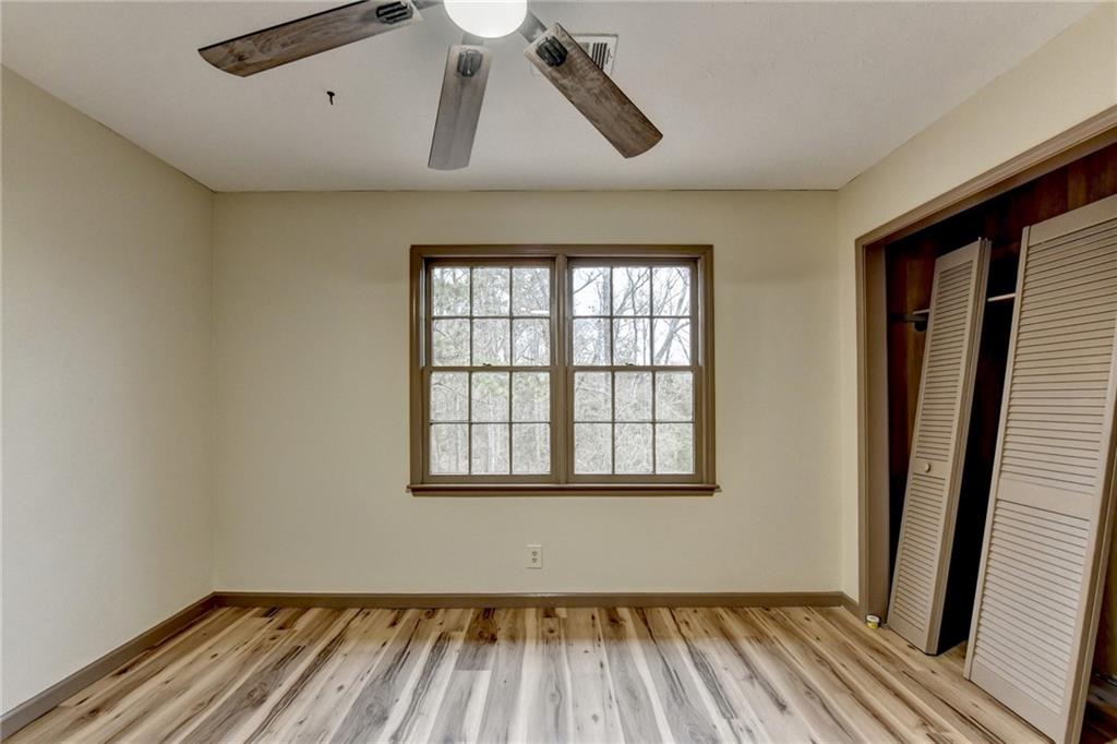 2377 Centerville Rosebud Road Loganville, GA 30052 - Photo 47 of 76 a view of empty room with wooden floor and fan