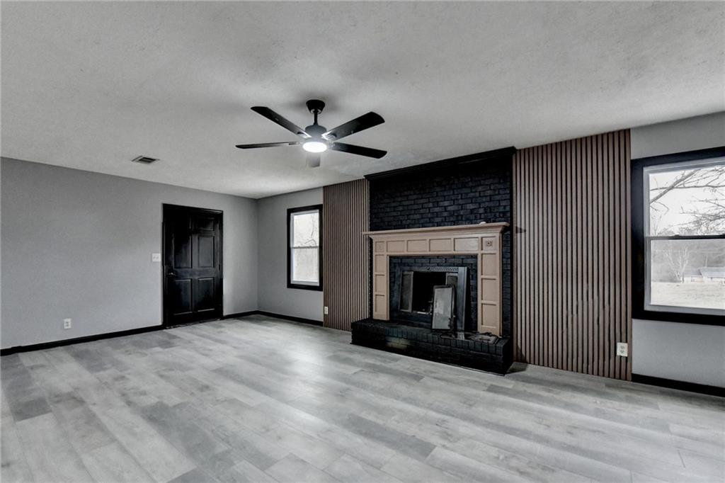 2377 Centerville Rosebud Road Loganville, GA 30052 - Photo 49 of 76 an empty room with windows and fireplace