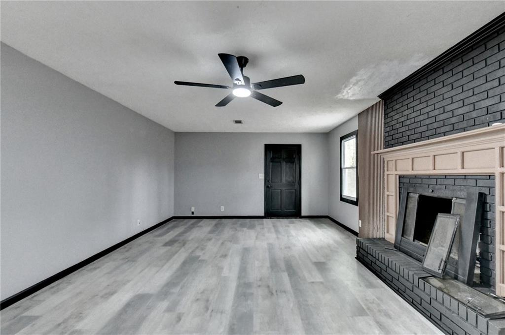 2377 Centerville Rosebud Road Loganville, GA 30052 - Photo 50 of 76 a view of an empty room with a fireplace and a window