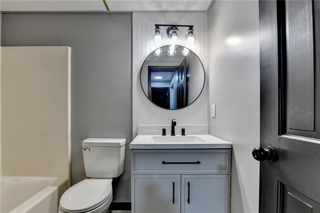 2377 Centerville Rosebud Road Loganville, GA 30052 - Photo 54 of 76 a bathroom with a toilet sink and mirror