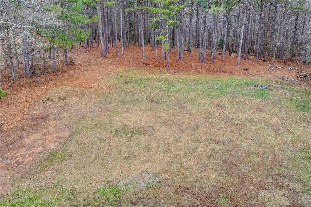 2377 Centerville Rosebud Road Loganville, GA 30052 - Photo 68 of 76 a backyard of a house with table and chairs