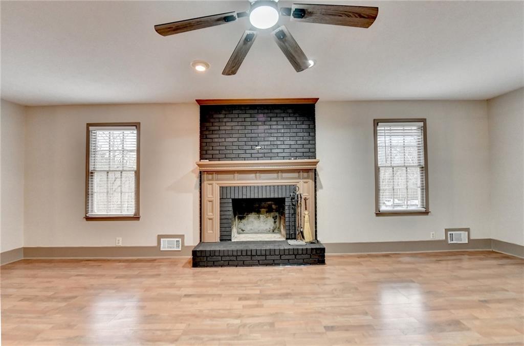 2377 Centerville Rosebud Road Loganville, GA 30052 - Photo 8 of 76 a view of empty room with a fireplace and windows