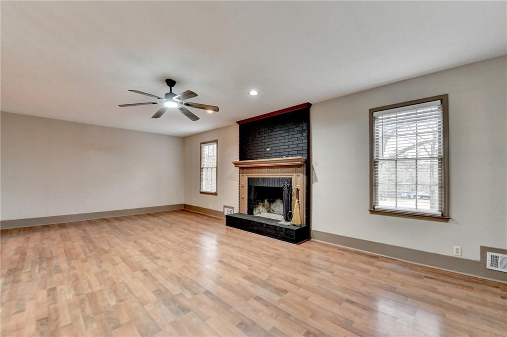 2377 Centerville Rosebud Road Loganville, GA 30052 - Photo 10 of 76 a view of an empty room with a fireplace and a window