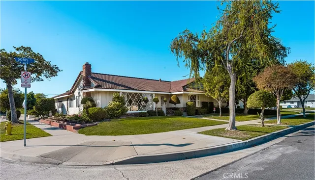 a view of a white house with a yard