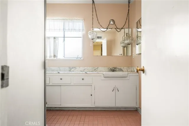 a bathroom with a sink toilet and mirror