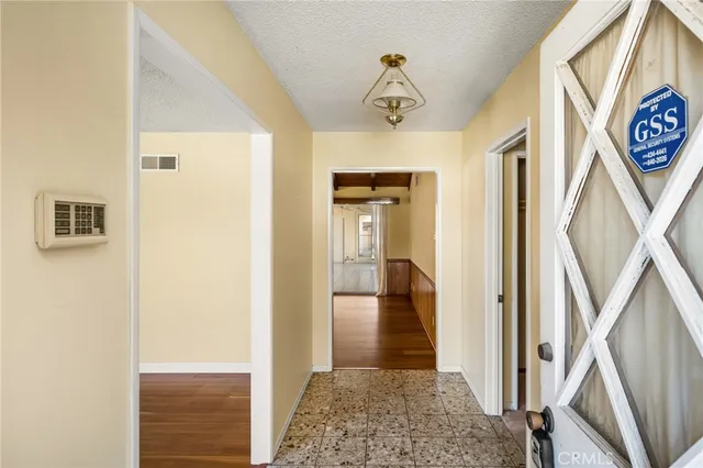 a view of a hallway with a dining area with bathroom