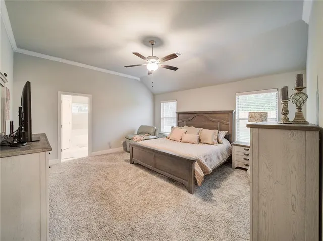 a spacious bedroom with a bed and a flat screen tv