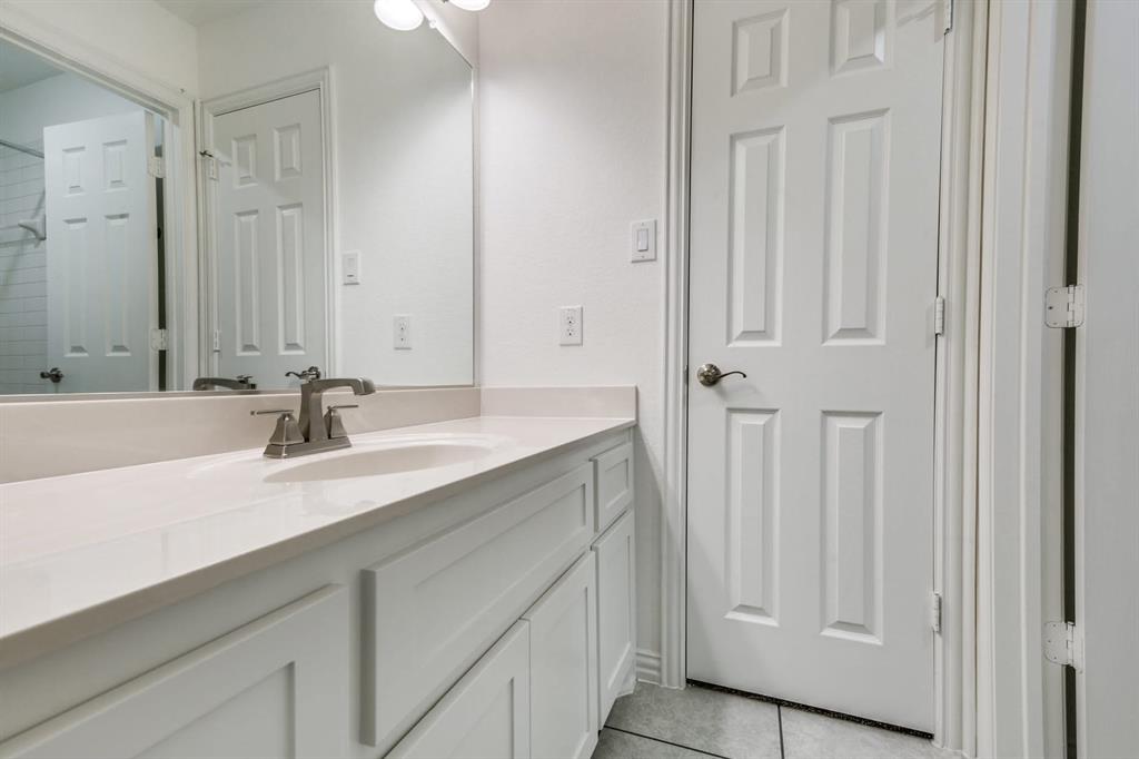 104 Sweetleaf Drive Red Oak, TX 75154 - Photo 21 of 36 Bathroom vanity with a white countertop and a brushed nickel faucet