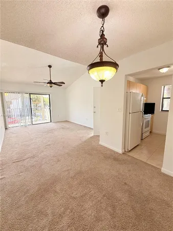 a view of empty room with a cabinet and chandelier