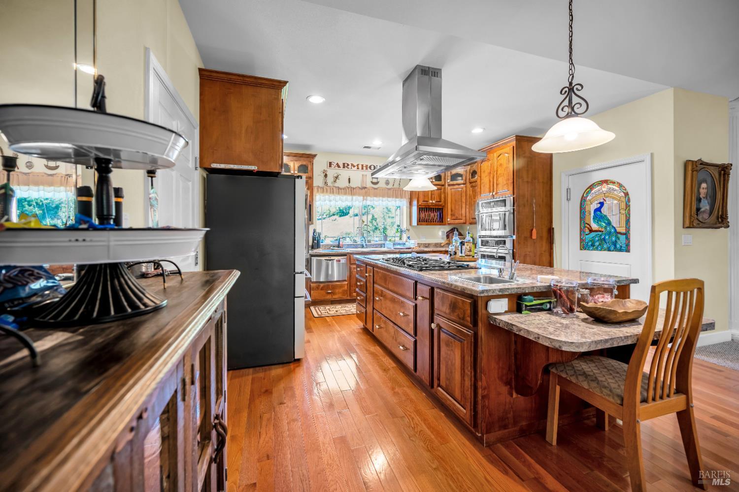 3970 Canyon Road Willits, CA 95490 - Photo 53 of 73 a kitchen with stainless steel appliances granite countertop a stove a sink a refrigerator and a wooden cabinets