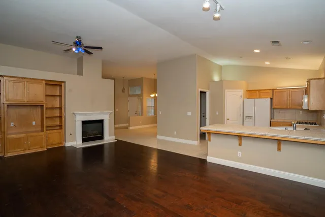 a view of a kitchen with sink microwave and cabinets