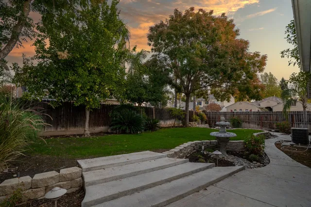 a view of a park with plants and a bench