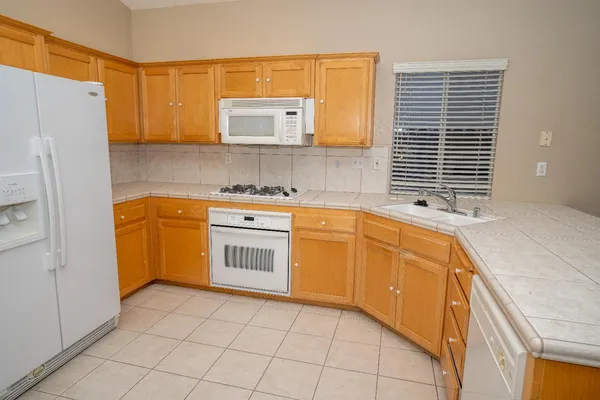a kitchen with a stove a sink and a refrigerator