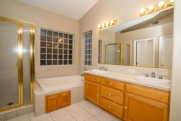 a bathroom with a granite countertop sink mirror and double