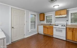 a view of a kitchen with stove top oven