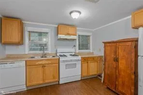 a kitchen with a stove a sink and a refrigerator