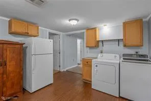 a view of storage utility and a utility room with washer and dryer