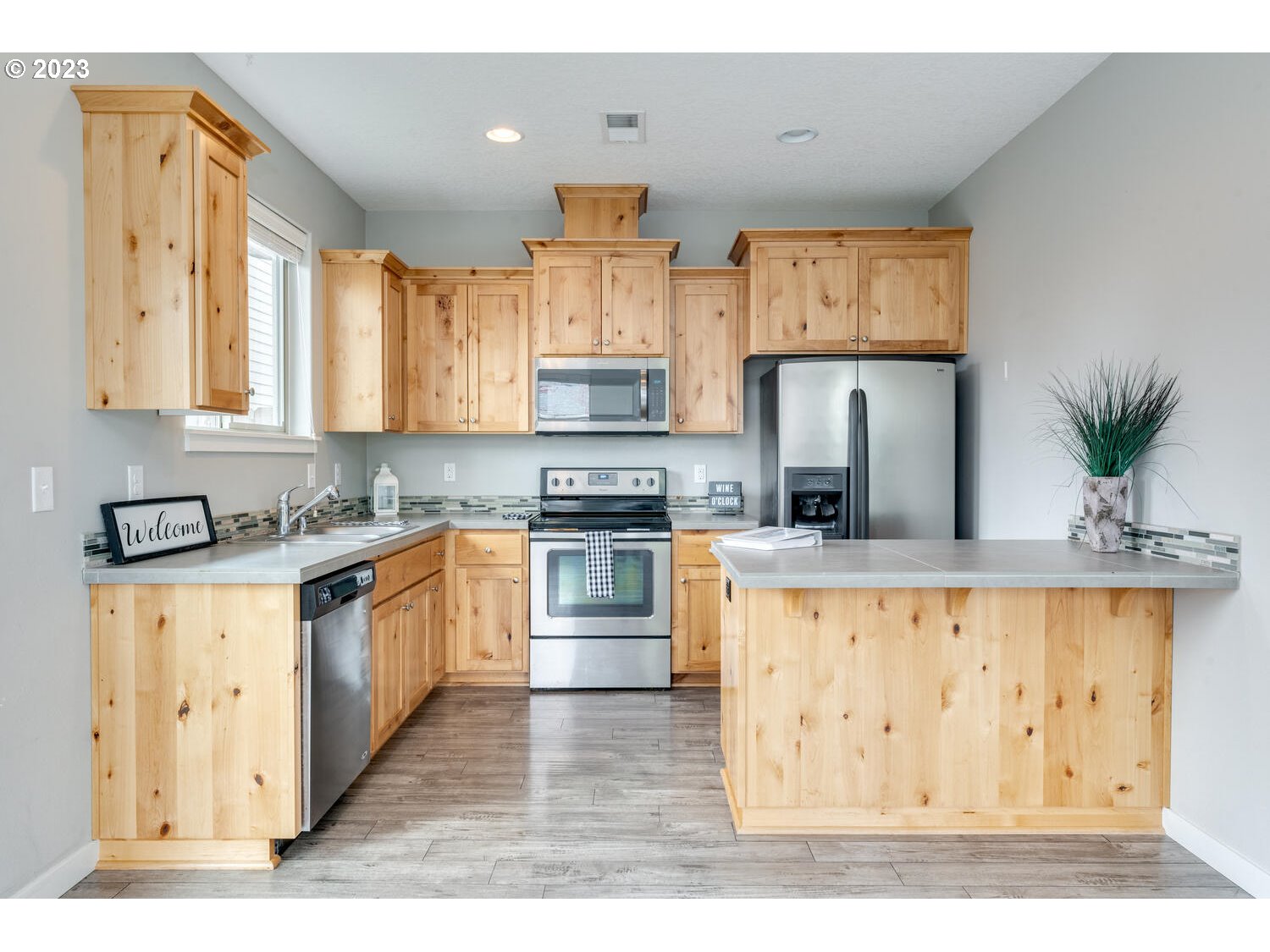 260 North 43rd Place Ridgefield, WA 98642 - Photo 4 of 20 a kitchen with stainless steel appliances granite countertop a stove a sink a refrigerator and white cabinets