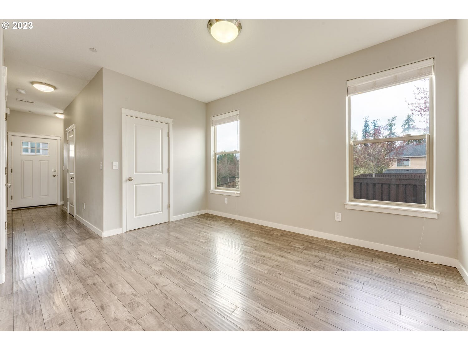 260 North 43rd Place Ridgefield, WA 98642 - Photo 5 of 20 an empty room with wooden floor and windows