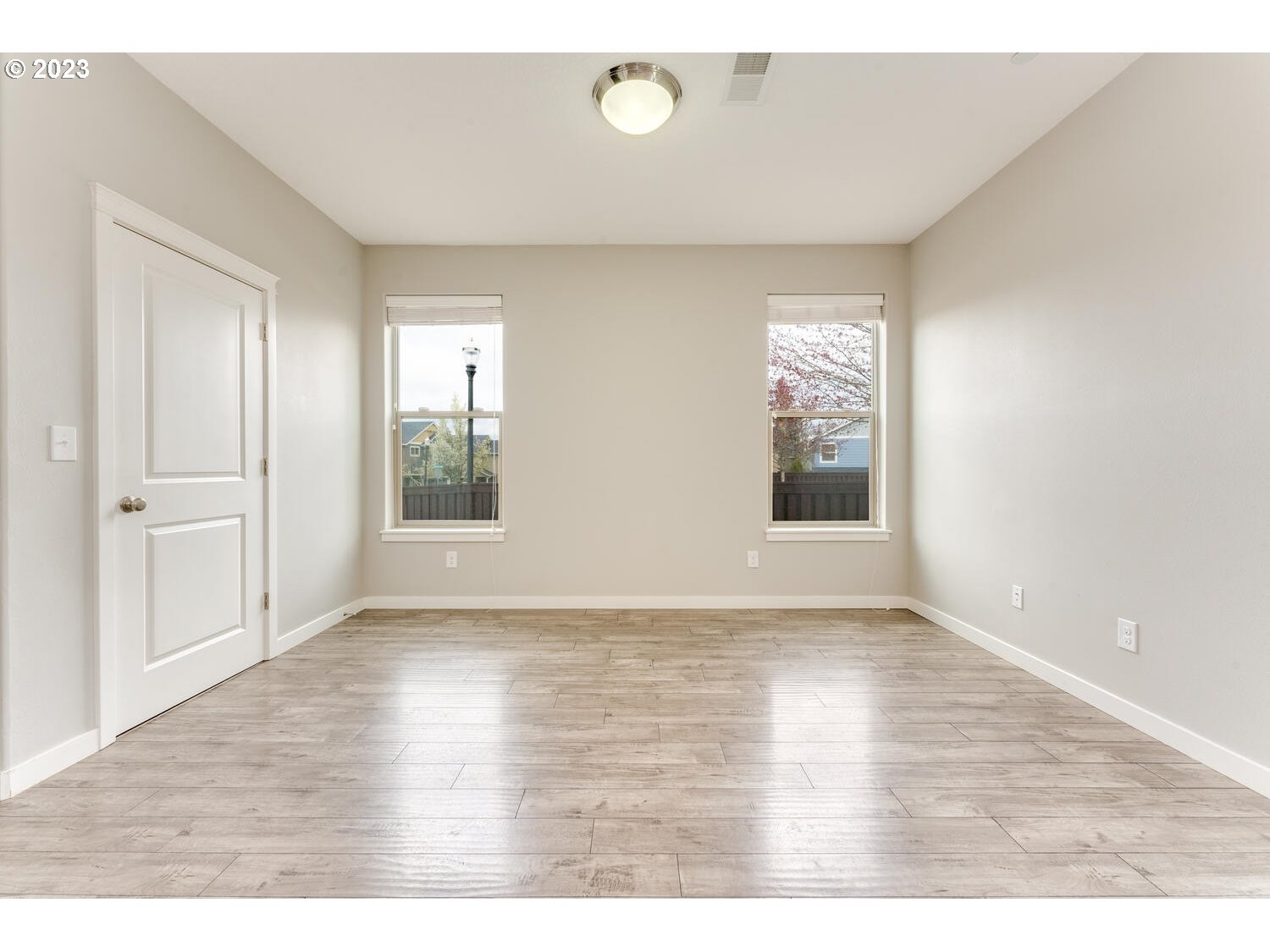 260 North 43rd Place Ridgefield, WA 98642 - Photo 6 of 20 a view of an empty room with window and wooden floor