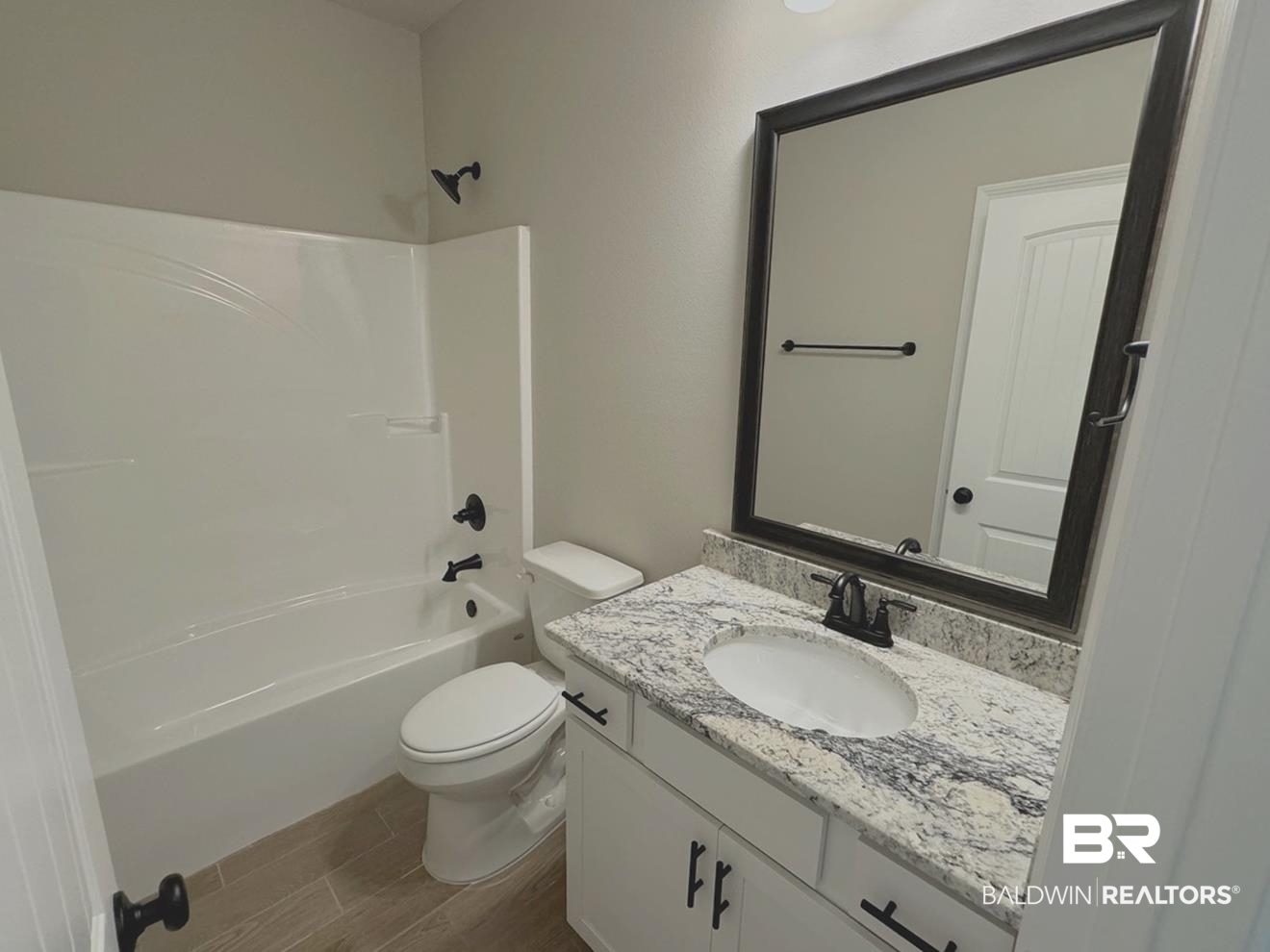 904 Sumter Loop Foley, AL 36535 - Photo 7 of 10 Full bathroom featuring shower / bathtub combination, vanity, hardwood / wood-style floors, and toilet