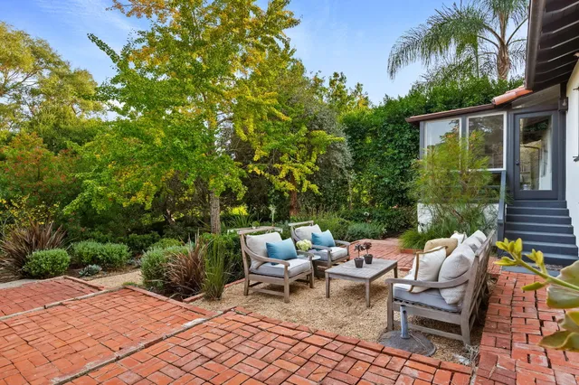 a view of a patio with couple of chairs