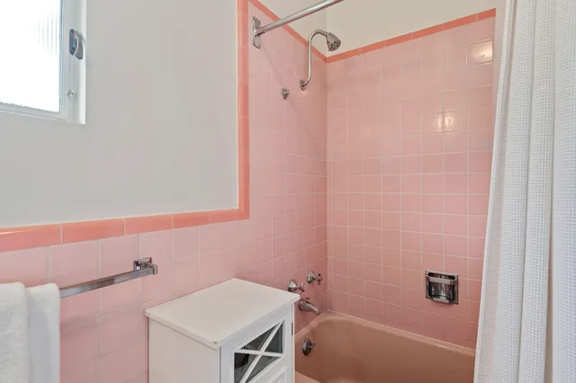 a bathroom with a shower curtain and a sink