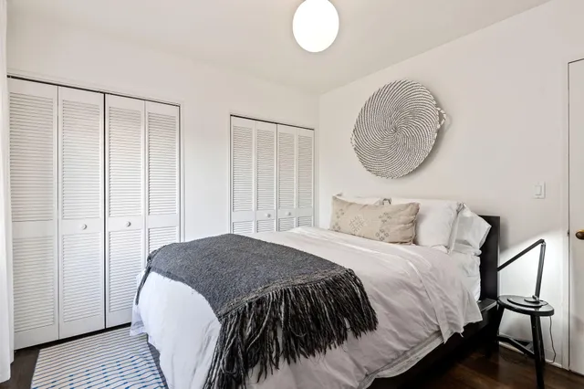 a bedroom with a bed and a mirror