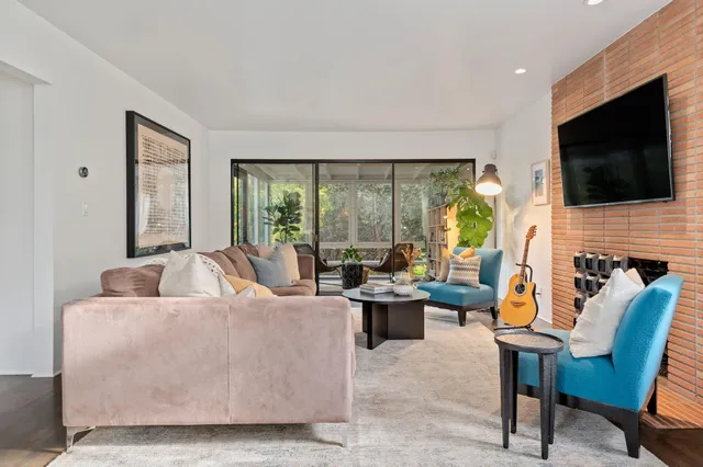 a living room with fireplace furniture and a flat screen tv