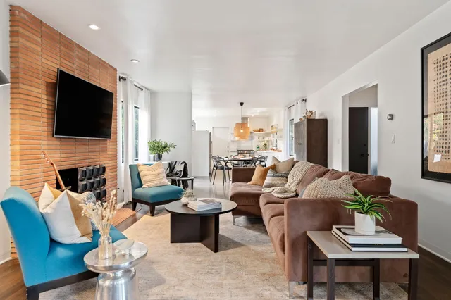 a living room with fireplace furniture and a flat screen tv