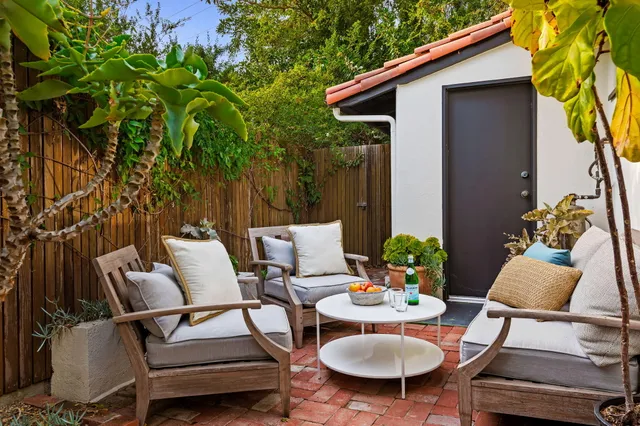 a view of a patio with couple of chairs and a chairs