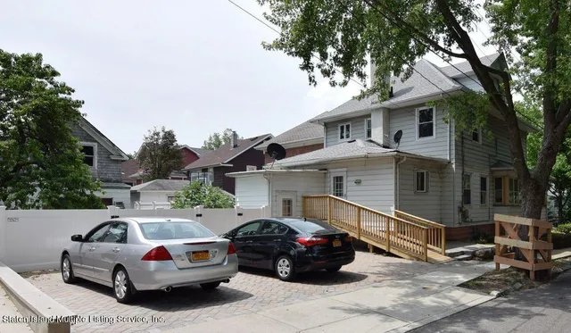 a front view of a house with parking space