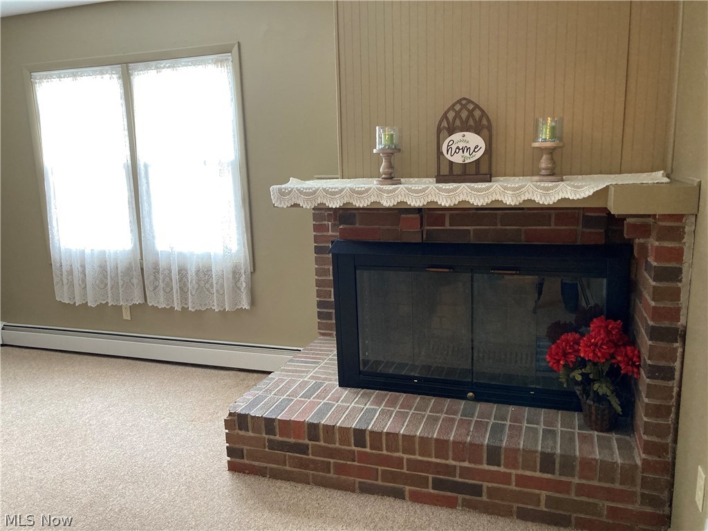 The wood-burning fireplace located in the in-law living space is a welcoming feature in the home.