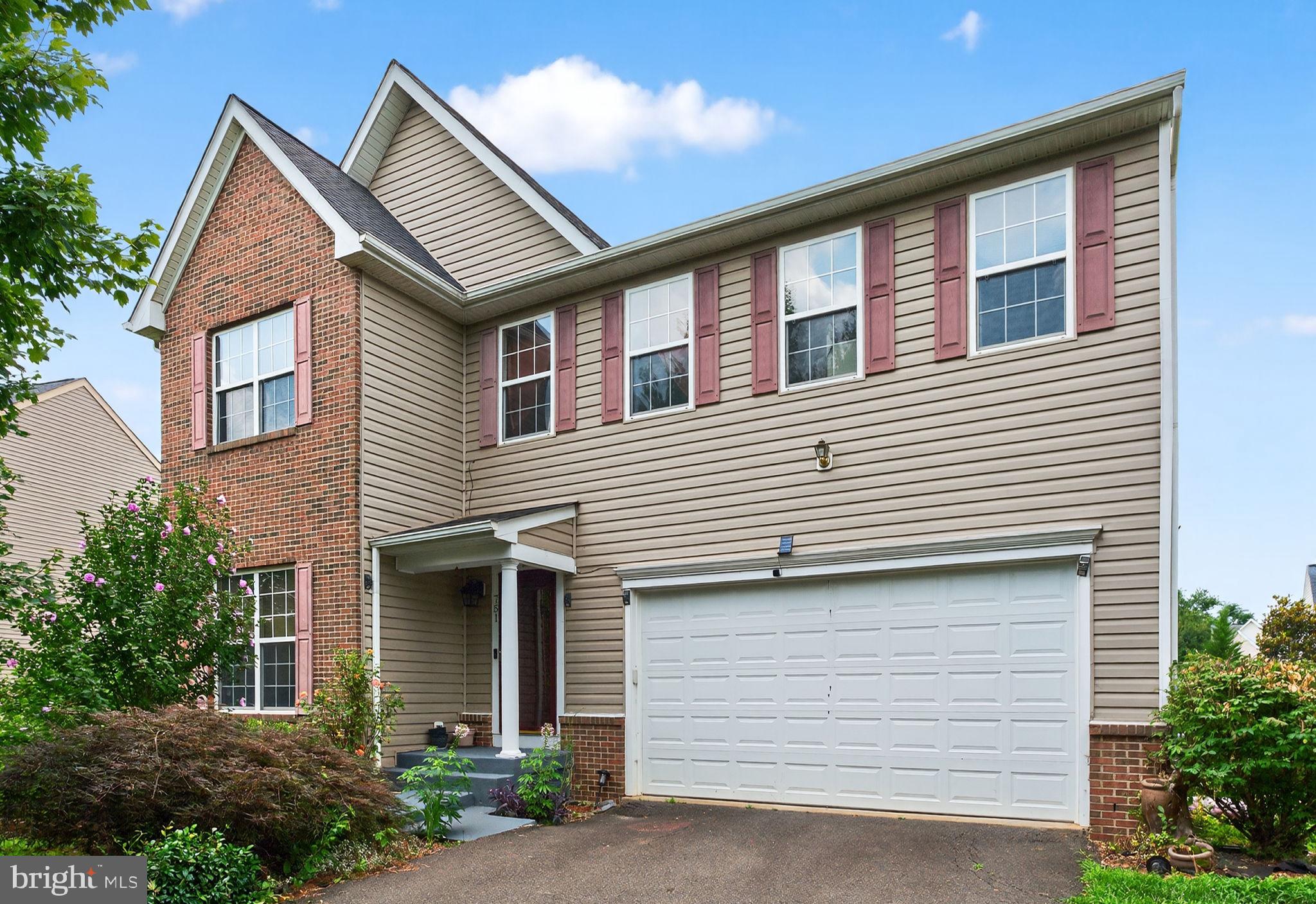 a front view of a house with garage