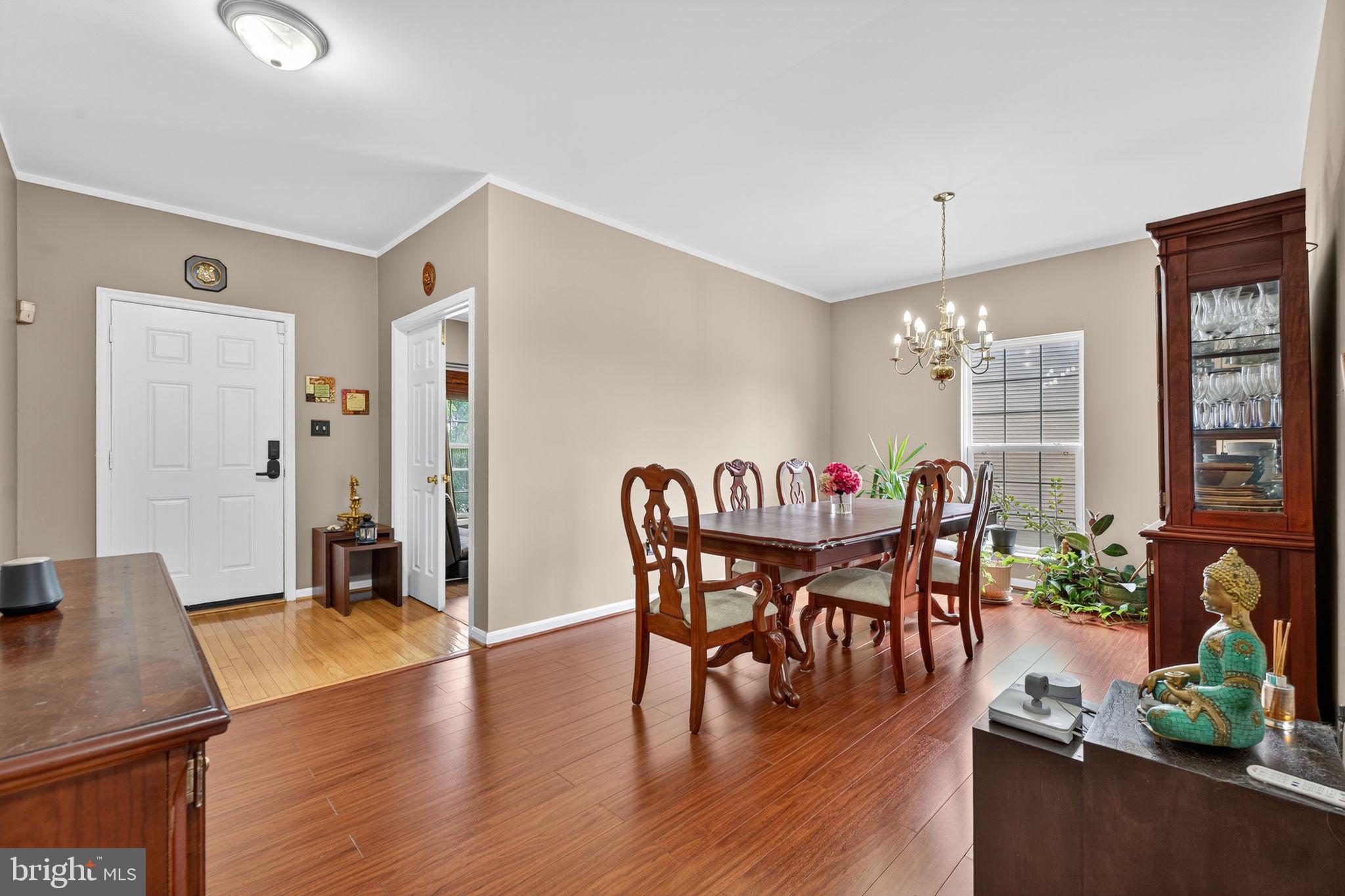 751 Holly Leaf Road Culpeper, VA 22701 - Photo 11 of 65 a dining room with furniture potted plants and wooden floor