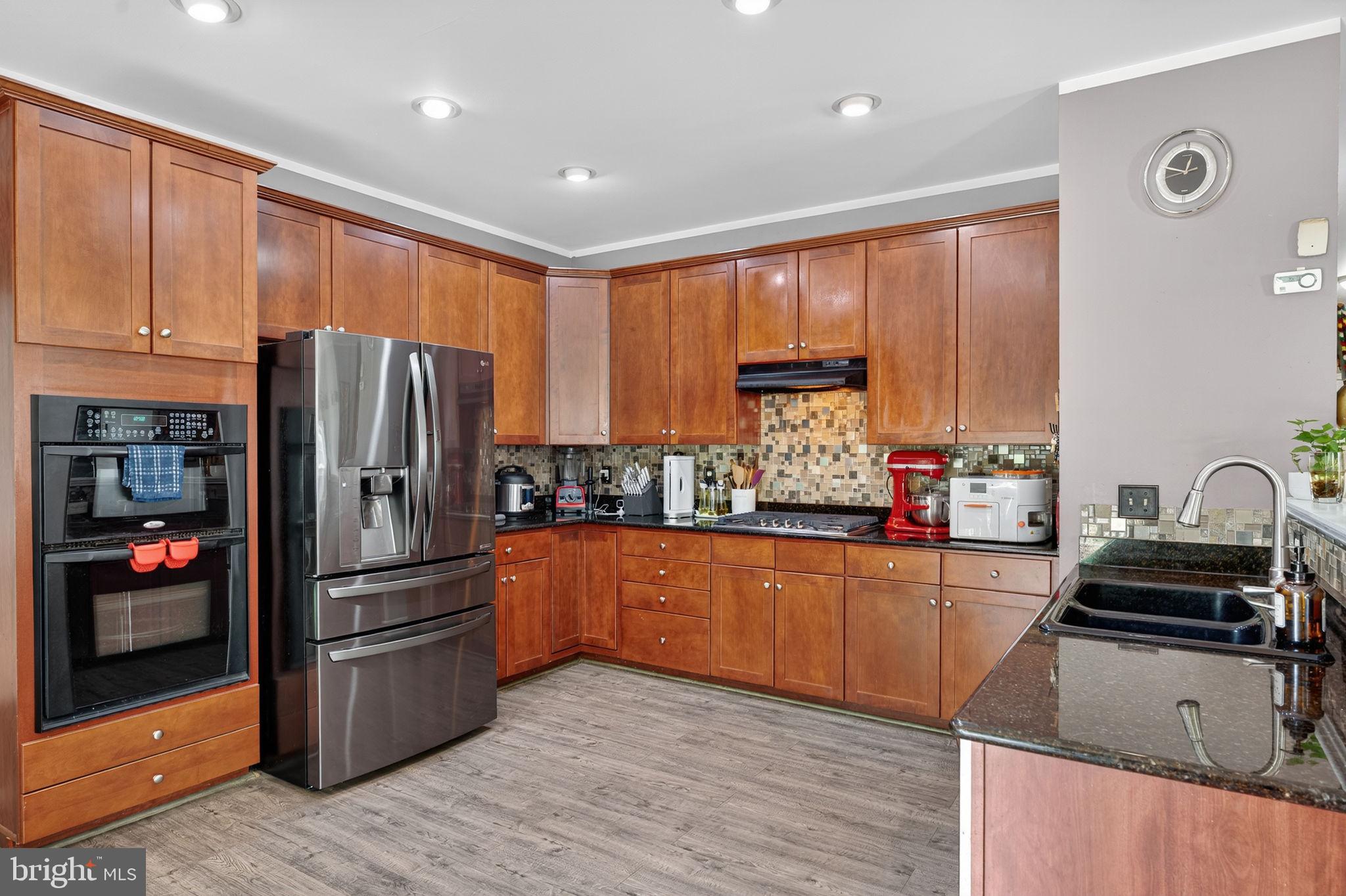 751 Holly Leaf Road Culpeper, VA 22701 - Photo 18 of 65 a kitchen with stainless steel appliances granite countertop a refrigerator stove and sink