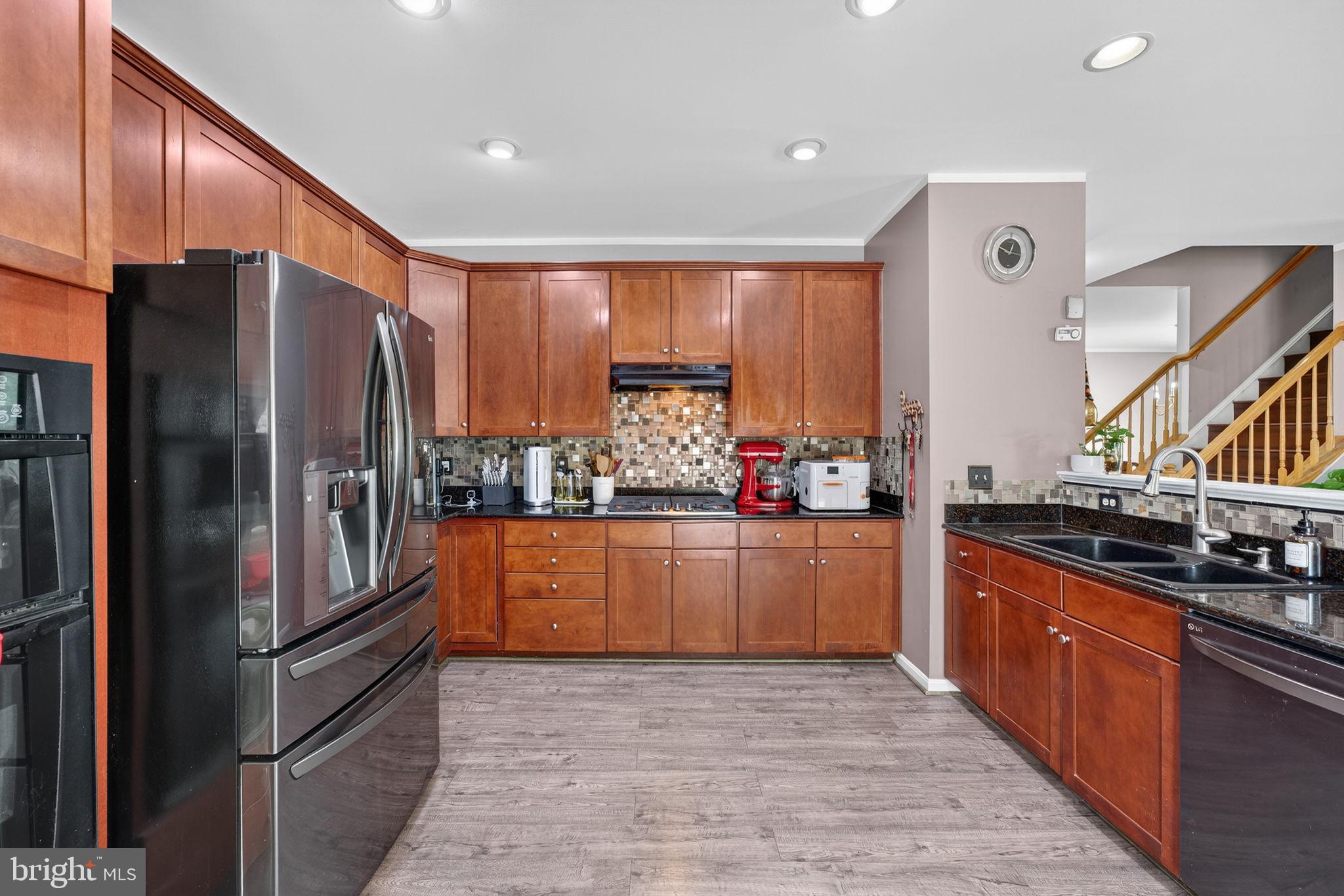 751 Holly Leaf Road Culpeper, VA 22701 - Photo 19 of 65 a kitchen with stainless steel appliances granite countertop a refrigerator and a stove