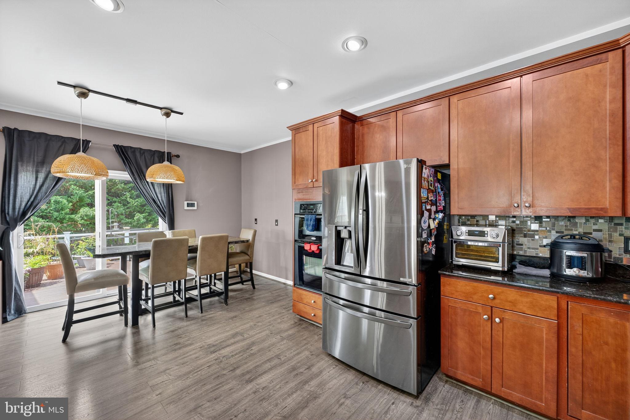 751 Holly Leaf Road Culpeper, VA 22701 - Photo 22 of 65 a kitchen with stainless steel appliances granite countertop a refrigerator stove and wooden floor