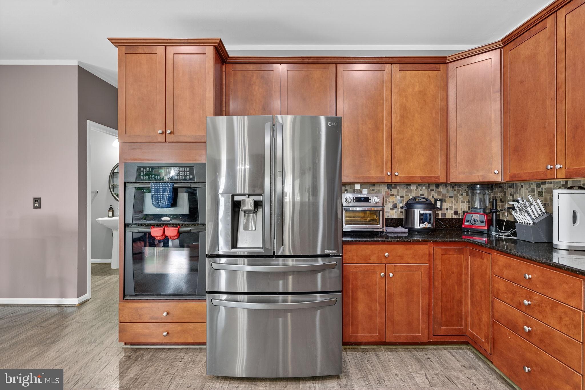 751 Holly Leaf Road Culpeper, VA 22701 - Photo 23 of 65 a kitchen with stainless steel appliances granite countertop a refrigerator sink and cabinets