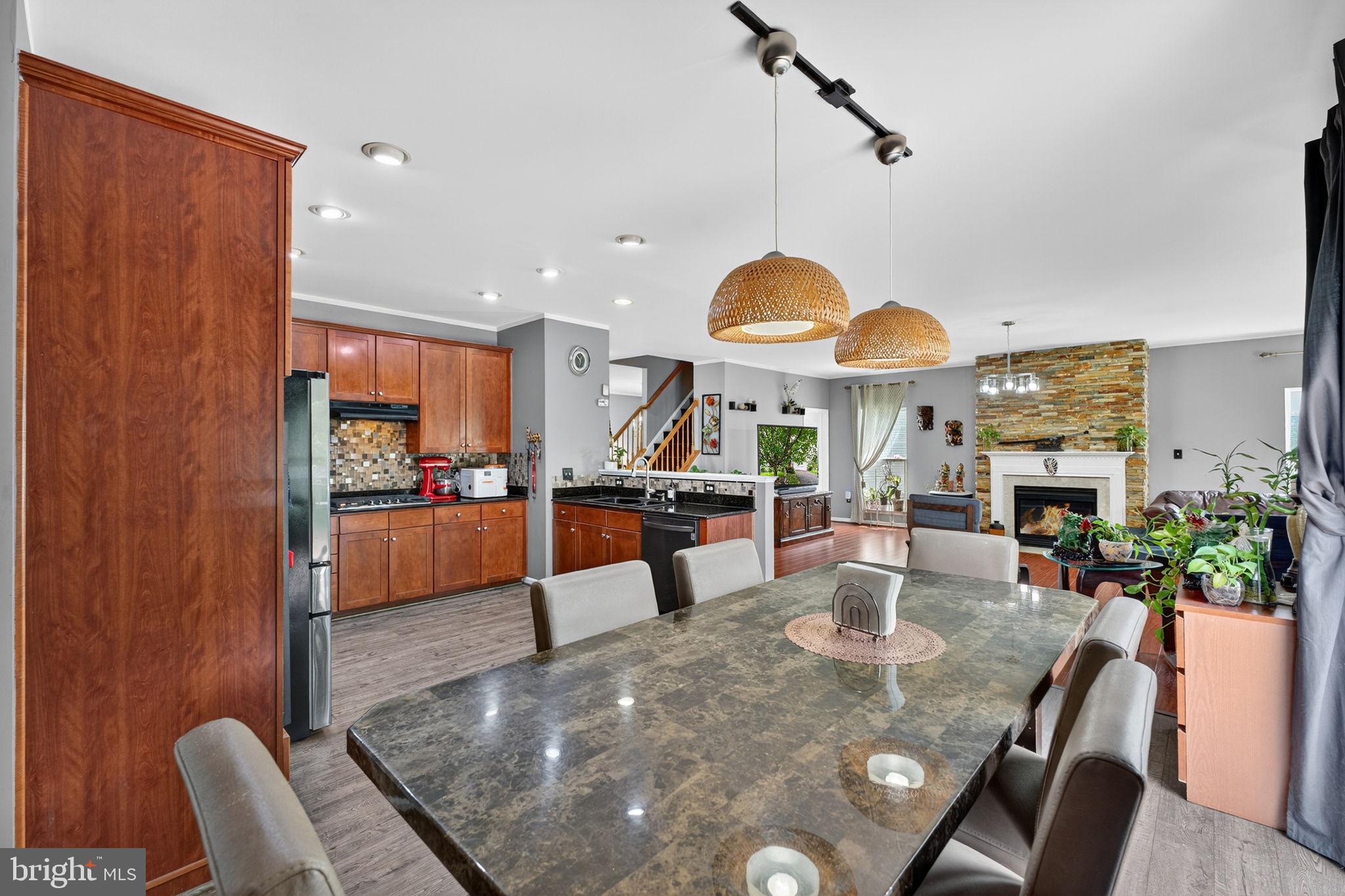 751 Holly Leaf Road Culpeper, VA 22701 - Photo 24 of 65 a view of a dining room and livingroom with furniture wooden floor a chandelier